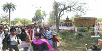 Visitors watching an artist posing as Mahatma Gandhi, father of nation