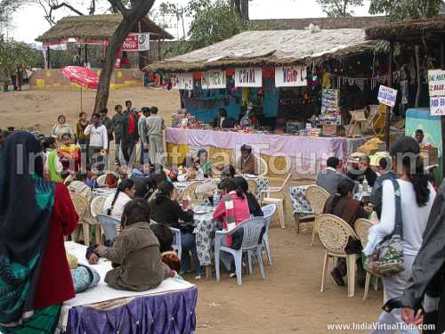 Some are enjoying food, others are waiting for chairs to be vacant